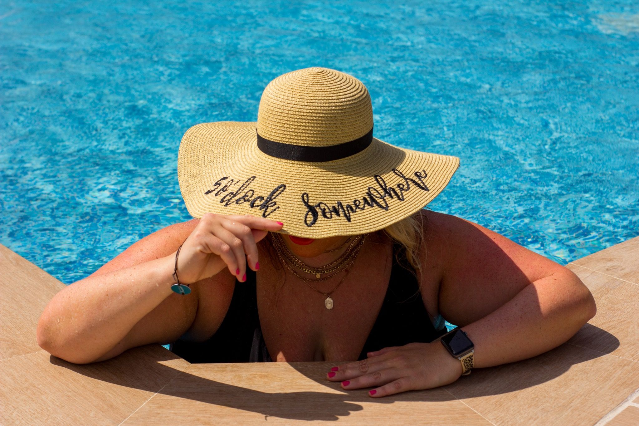 Poolside in a wide-brimmed sun hat